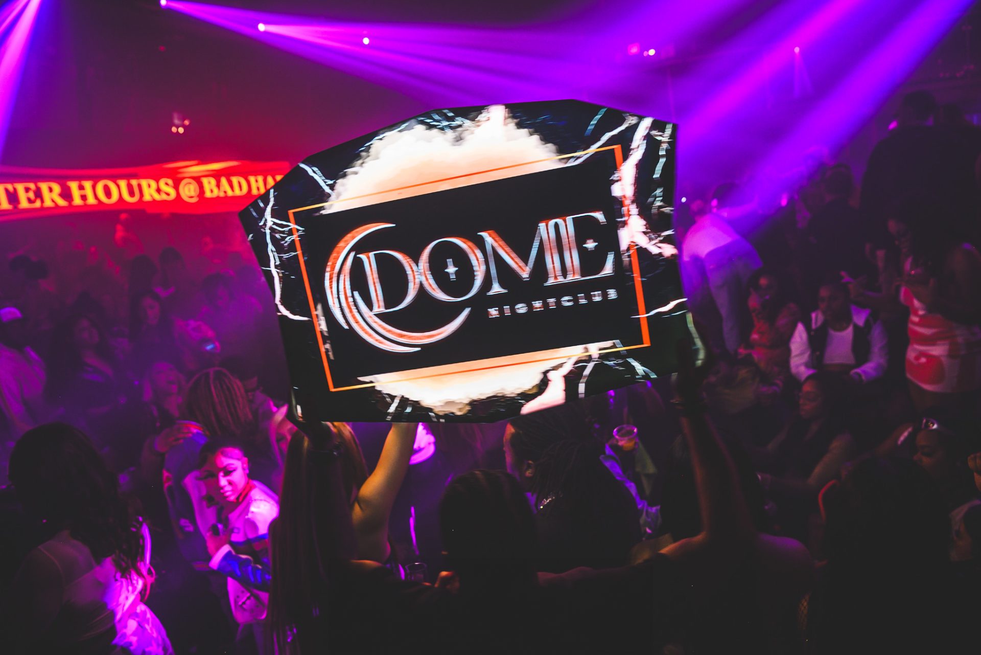 Crowd dancing under purple lights at Dome Nightclub Houston